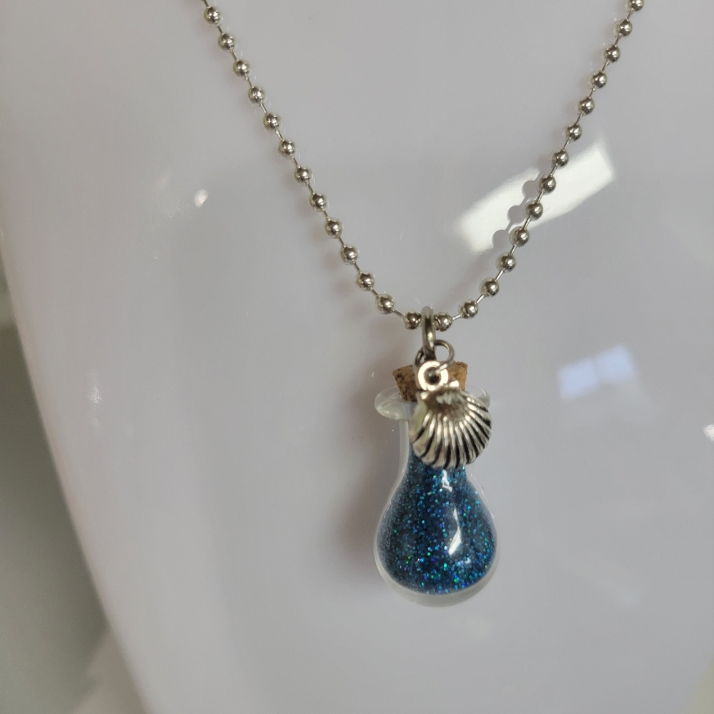 TEAL HOLOGRAPHIC glitter pixie fairy dust necklace with small shell charm.